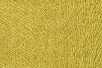 Fototapeta premium Yellow background from soft textile material. Fabric with natural texture.