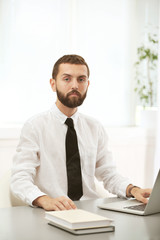 Fototapeta premium Businessman working on laptop in office