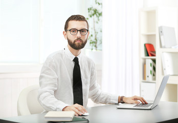 Businessman sitting at table in office
