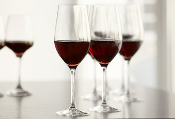 Glasses with red wine in a row on a table