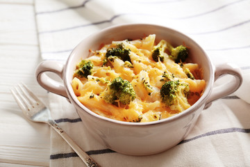 Delicious pasta Al Forno in ceramic bowl and napkin on white wooden table