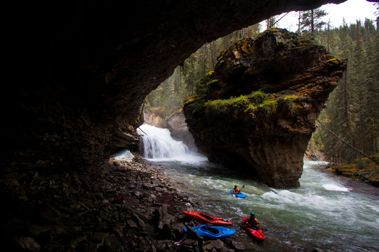 A group of male kayakers paddling Johnston Canyon, Banff National Park, AB