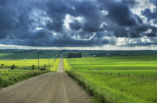Country road with storm clouds near Cremona, Alberta, Canada