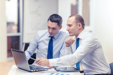 two businessmen having discussion in office