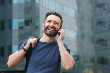 Happy mature guy talking on cell phone
