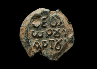 Round antique post seal with greek letters on it