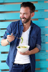 Mature man eating healthy food and smiling