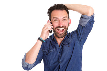 Excited mature man using on cellphone and laughing