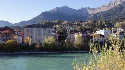 Historic building by the Inn river with the mountains in the background in Innsbruck, Austria