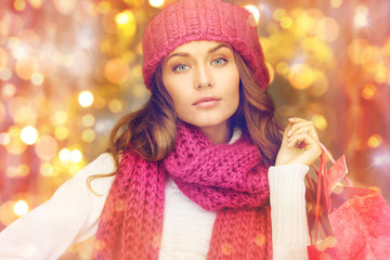 happy woman in winter clothes with shopping bags