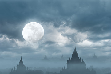 Amazing castle silhouette under moon at mysterious night. Fantasy  background in vintage style with old Buddhist Temples Sulamani and Tha Beik Hmauk Gu Hpaya at Bagan Kingdom, Myanmar (Burma)