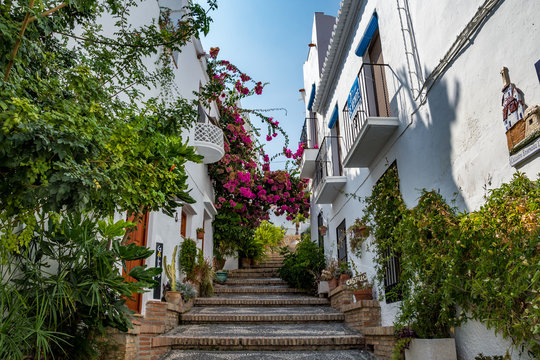 Fototapeta Beautiful narrow street in Salobrena (Salobreña) old town, leading the the castle, Spain