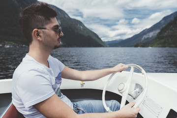 Man drive an electric boat on a lake in Austria - 122632330