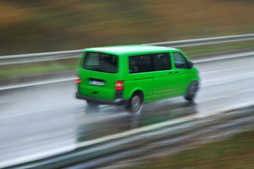 Fototapeta na wymiar Van car drive on wet road