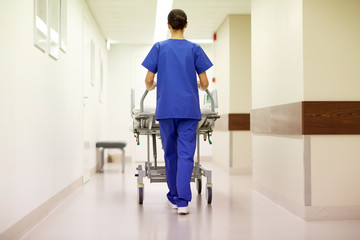 nurse carrying hospital gurney to emergency room - obrazy, fototapety, plakaty