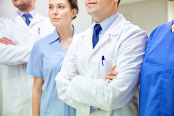close up of medics or doctors at hospital corridor