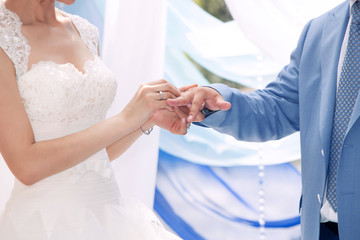 Obraz na płótnie Canvas bride dresses a ring to the groom