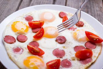 Fried eggs with sausage slices
