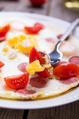 Fried eggs with sausage slices