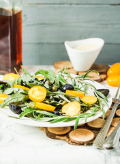 green salad with arugula, yellow tomatoes,grapes, sesame, select