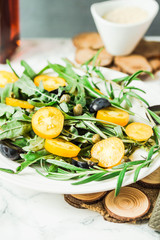 salad with arugula, yellow tomatoes,grapes, sesame, tinting