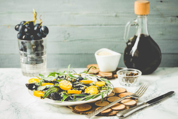 green salad with arugula, yellow tomatoes, olives and sesame,tin