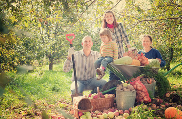 Fototapeta premium Happy family with harvest in garden