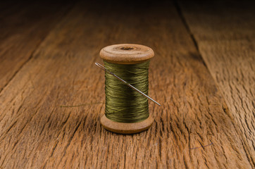 Fototapeta na wymiar retro wooden spool thread with needle