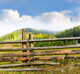 wooden fence on mountain meadow