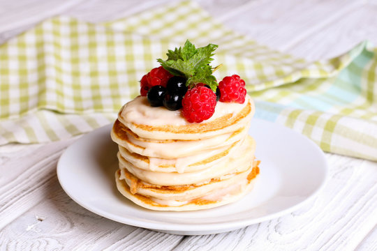 Summer cottage cheese pancakes on white plates on a table