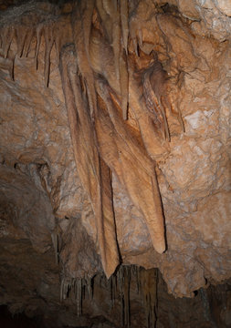 big stalactites hanging from a cave ceiling