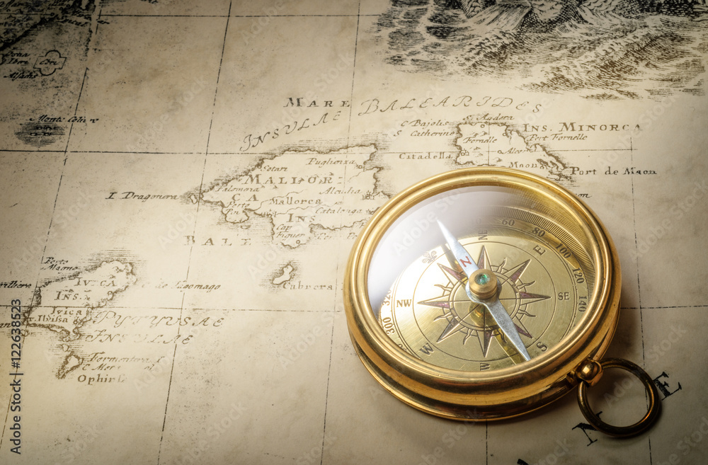 Poster old vintage retro compass on ancient map background. travel geography navigation concept background.