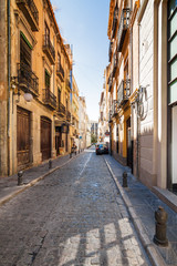Fototapeta na wymiar Sunny view of the street of Granada, Andalusia province, Spain.