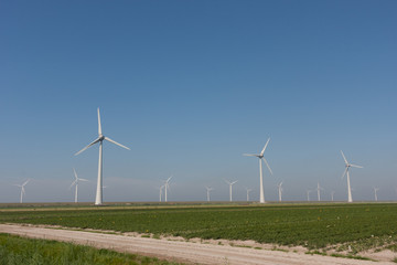 Windturbines producing green alternative energy - obrazy, fototapety, plakaty