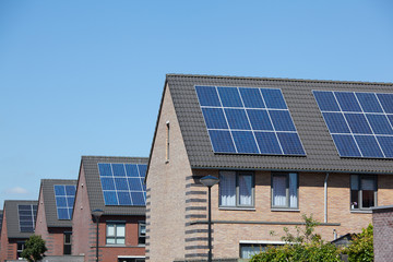 Modern houses with solar panels on the roof for alternative ener