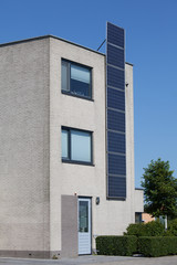Modern house with solar panels on the wall for alternative energ