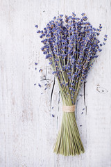 Dry lavender bunch on vintage wooden table from above. Rustic style.