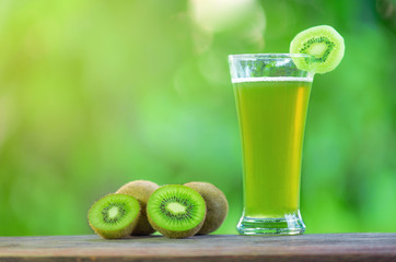 kiwi juice and kiwi on wooden table outdoor