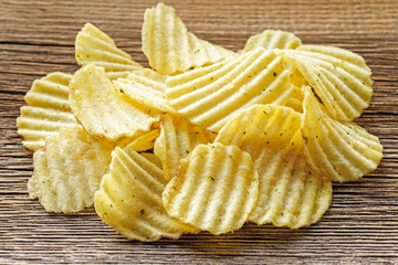 potato chips on rustic woden background