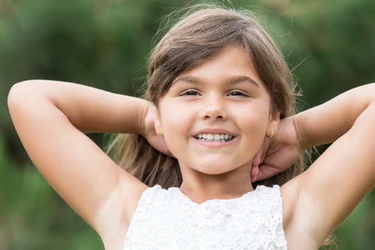 Portrait of cool attractive tanned little girl outdoors. 