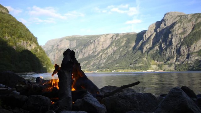 Campfire on the shore of a Fjord in Norway during summer