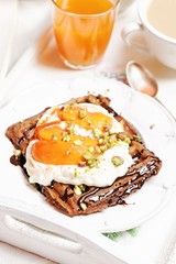 Chocolate waffles with cream and peaches