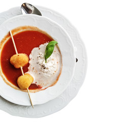 Tomato soup. Appetizer with two breadballs and cream.