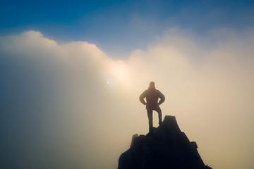 Hiker standing on a cliffs edge