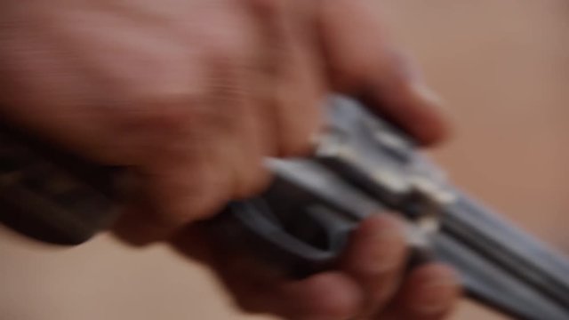 Close up loading a gun