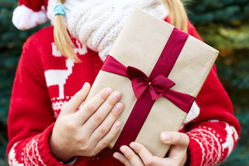 A child holds in hands Christmas present