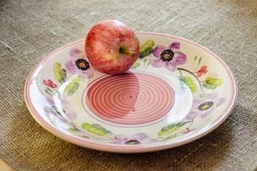red apples on the ceramic plate