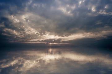 Fototapeta na wymiar Amazing sunrise landscape. Calm lake water with clouds reflection