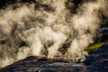 Steam from geysers on the rocky banks of the river. Upper Geyser Basin, Yellowstone National Park, Wyoming