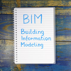 Obraz premium BIM- Building Information Modeling written in notebook on wooden background